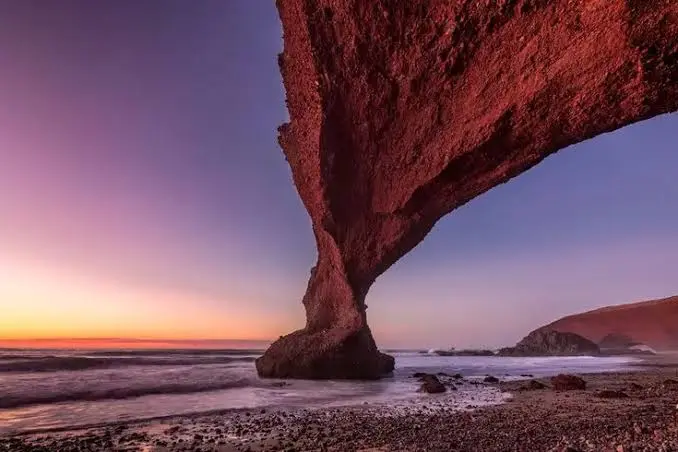 Legzira Beach's red rock arch and cliffs